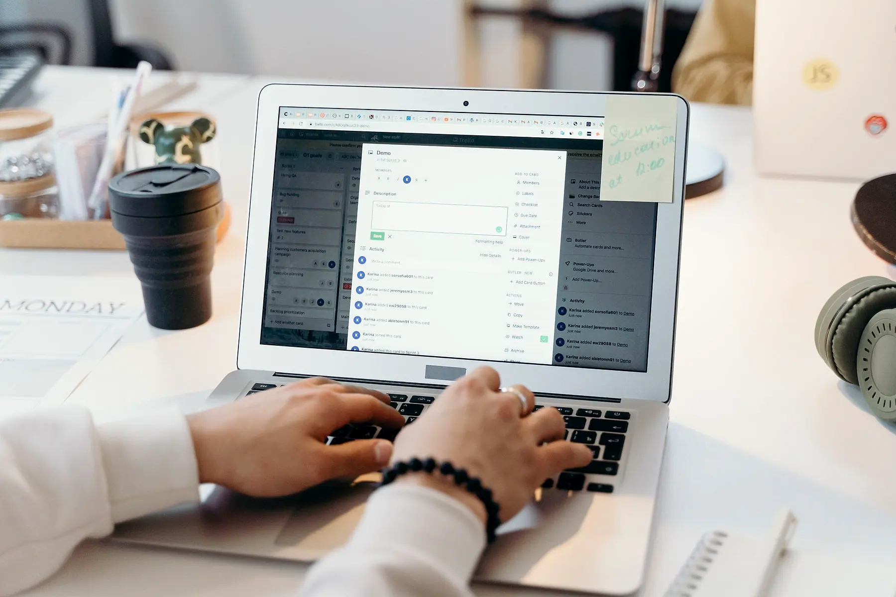 Hands typing on a laptop with a list of incoming messages on the screen