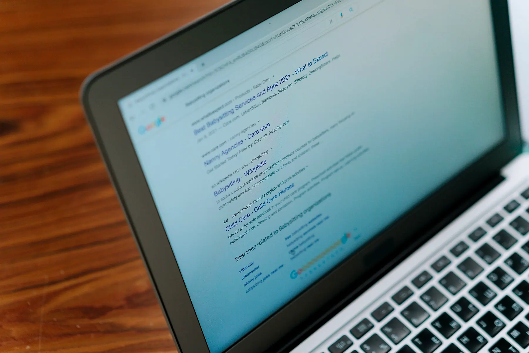 A laptop open on a page of Google search results