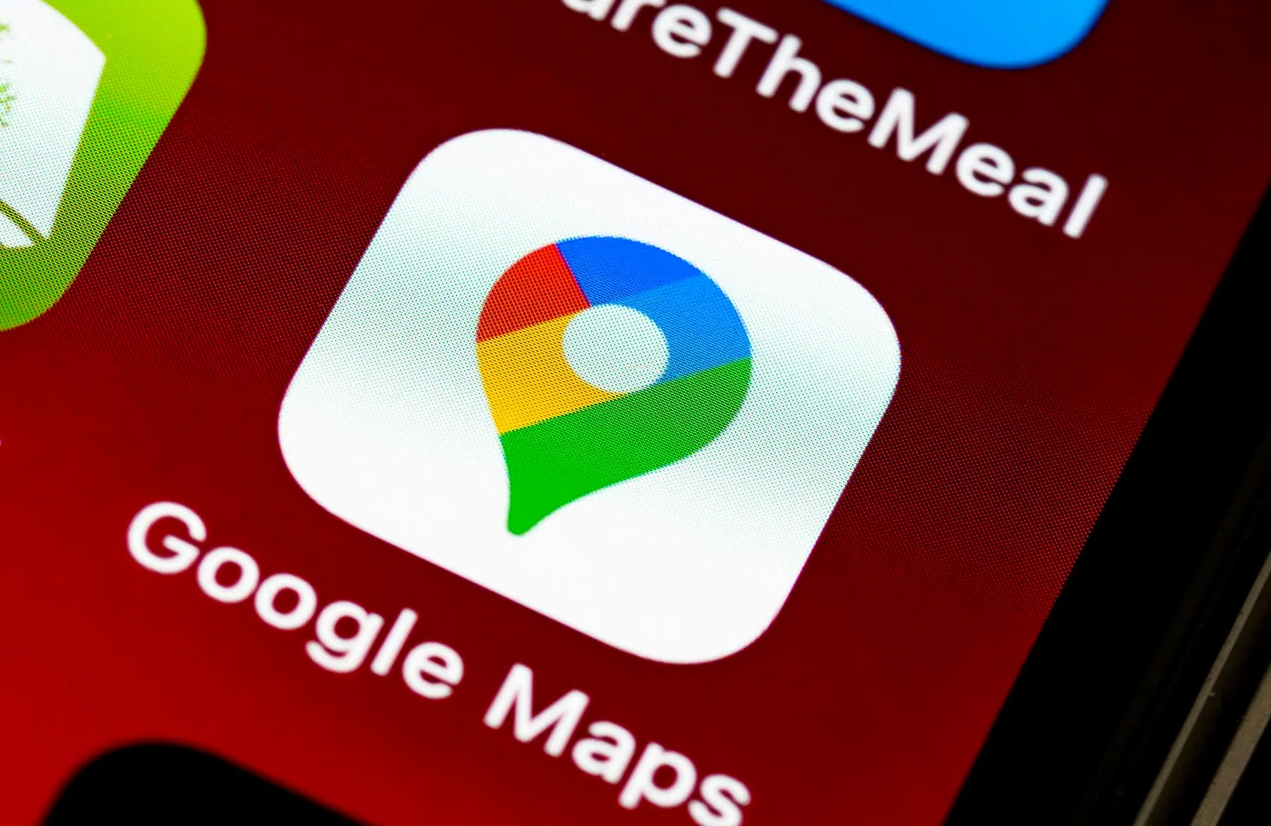 The Google Maps app icon on a phone screen, close up