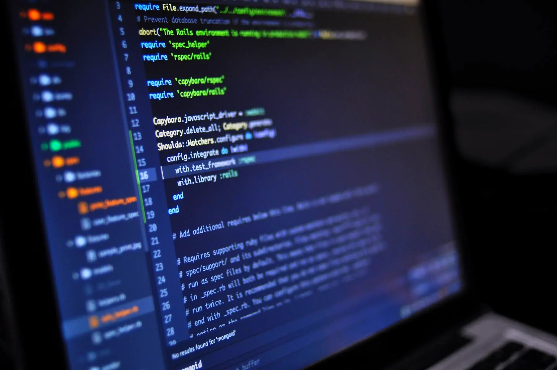 Code open in an editor on a laptop screen, with the project files listed down the side